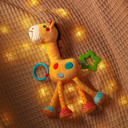 Yellow hanging baby rattle attached to a playpen