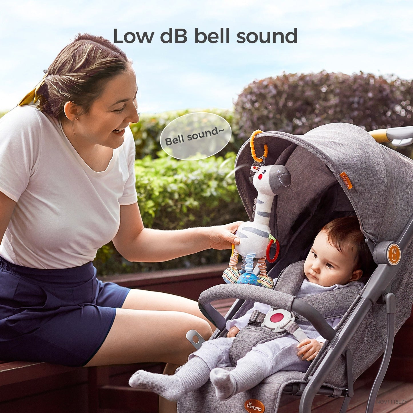 White zebra baby rattle used on a stroller with gentle bell sound