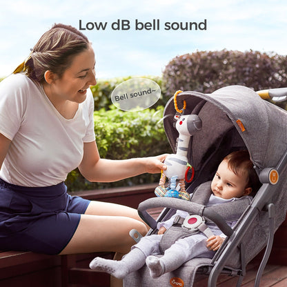 White zebra baby rattle used on a stroller with gentle bell sound