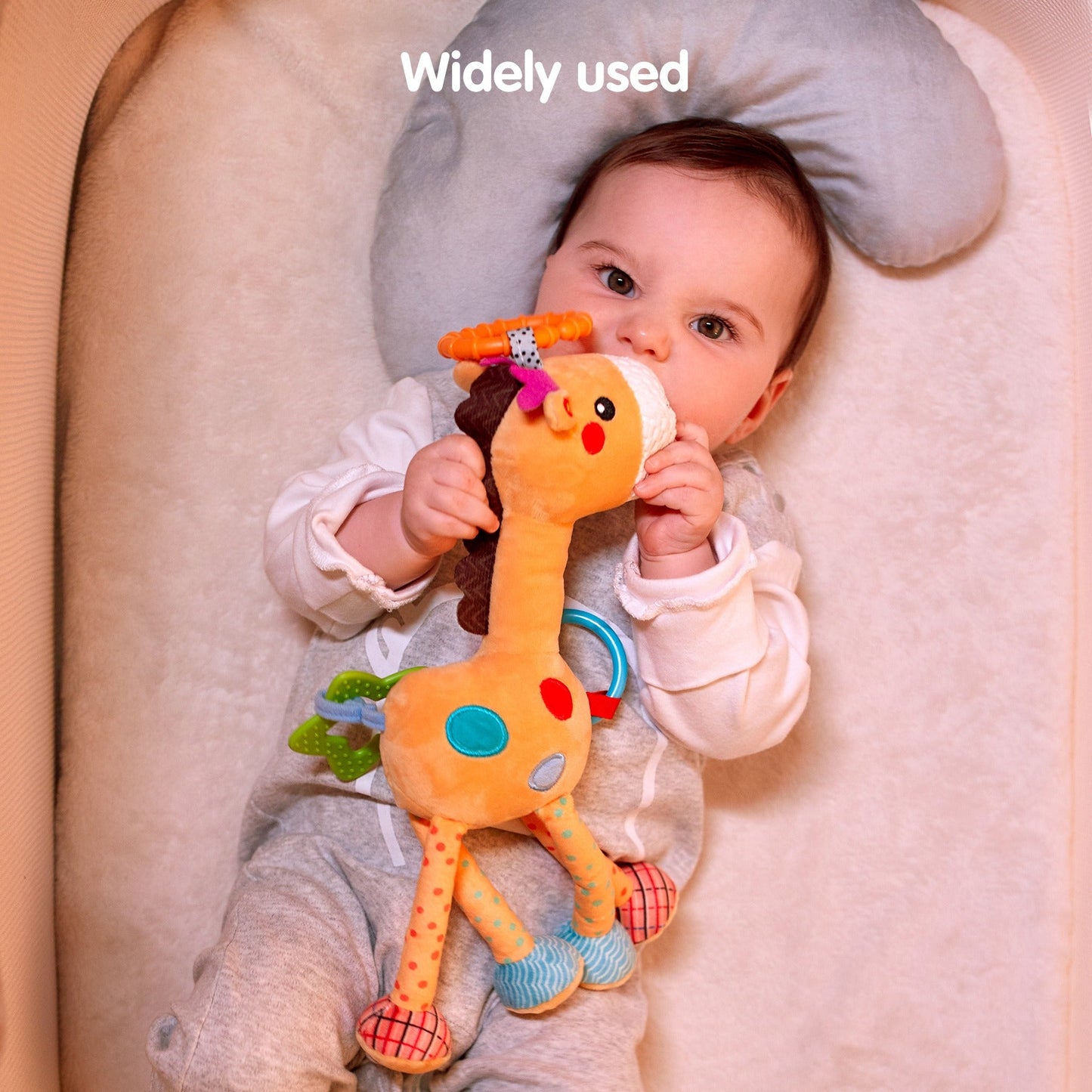 Yellow hanging baby rattle toy shown as washable