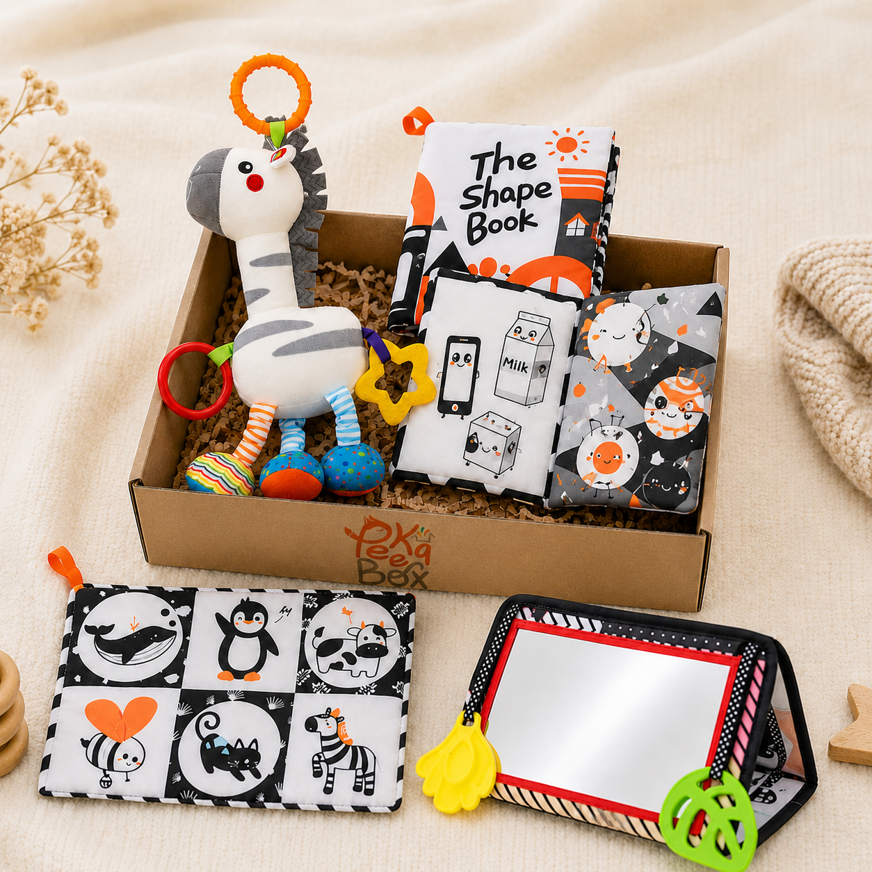 Peekabox Sensory Discovery Box with soft baby book, hanging sensory panel, giraffe and zebra rattle toy, and tummy time mirror