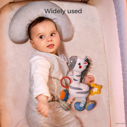 White zebra hanging rattle attached to a stroller